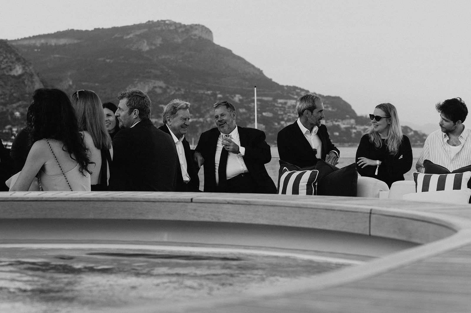Guests talking on a yacht deck off Monaco, an original black-and-white photograph from the LUKEVENT archive
