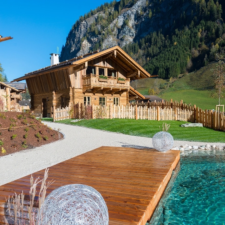 Wooden chalets in front of the mountains