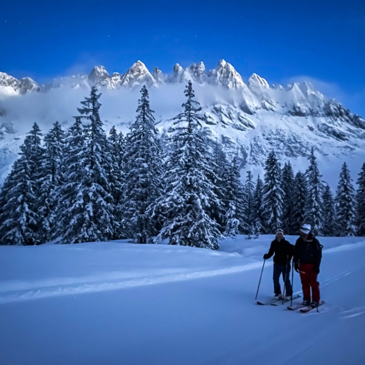 Two people skiing in the mountains