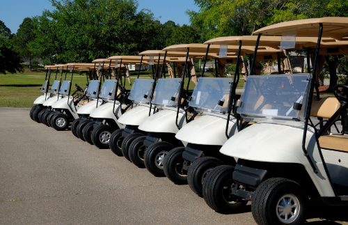 Nine golf cars standing next to each other